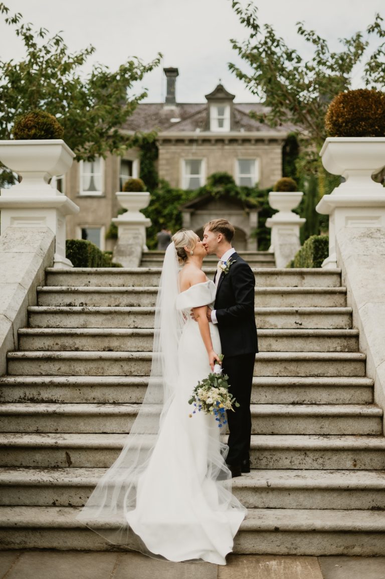 bride and groom romantic kiss famous staircase Tinakilly Country House wedding Ireland WeddingWithMe