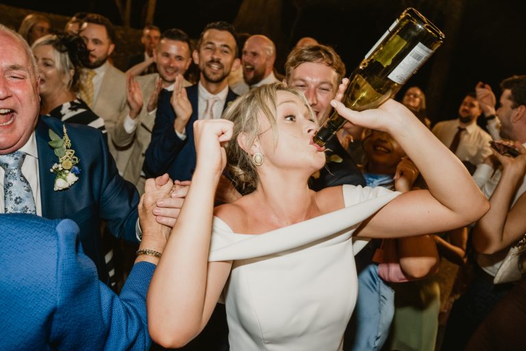 Stunning image of the bride in the spotlight, dancing with elegance and fun during the wedding party at Tinakilly Country House. Highlights her radiant energy and the celebratory atmosphere. Captured by WeddingWithMe, perfect for professional wedding photography portfolios and SEO-optimized website content.