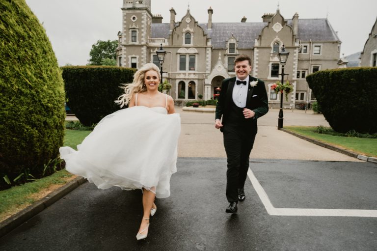 Iconic and romantic wedding portrait of the bride sitting in the groom’s arms as they look into each other’s eyes. This intimate and emotional moment captures deep connection, love, and timeless elegance, making it a signature image of the wedding day. Set in a beautiful Irish wedding venue, this photograph by WeddingWithMe highlights fine art wedding photography and cinematic storytelling.