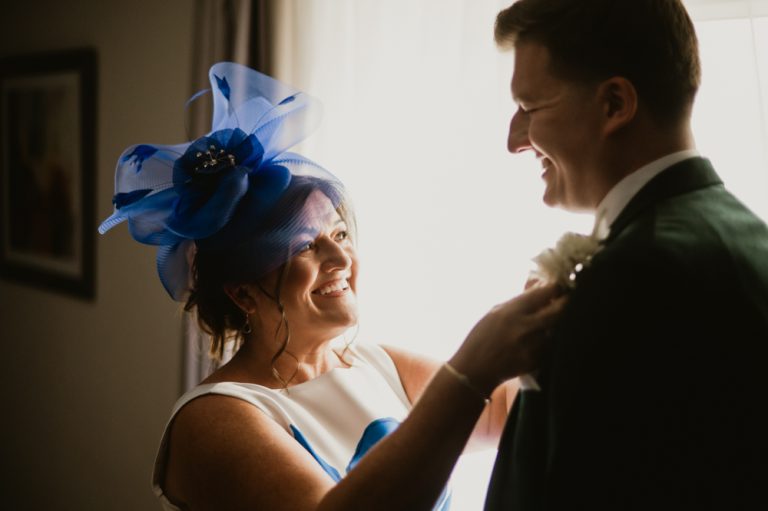 Mother adjusting groom's suit at Killashee Manor House – Irish wedding photography, Bridgerton inspired wedding
