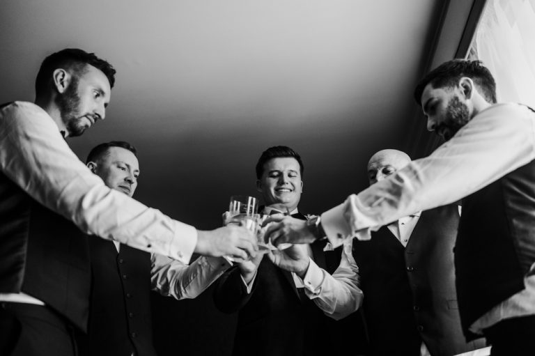 Groomsmen toasting while getting ready at Killashee Manor House – Irish wedding photography, Bridgerton inspired wedding